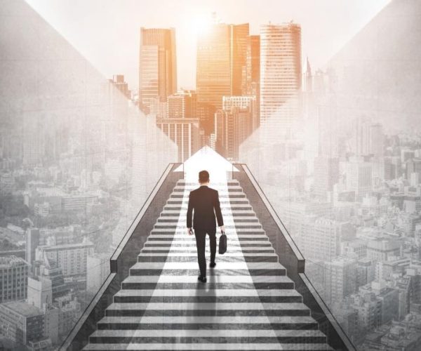 Ambitious business man climbing stairs to success.